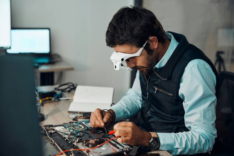 Technician, computer and engineer repair motherboard, microcircuit or electronic device in a worksh